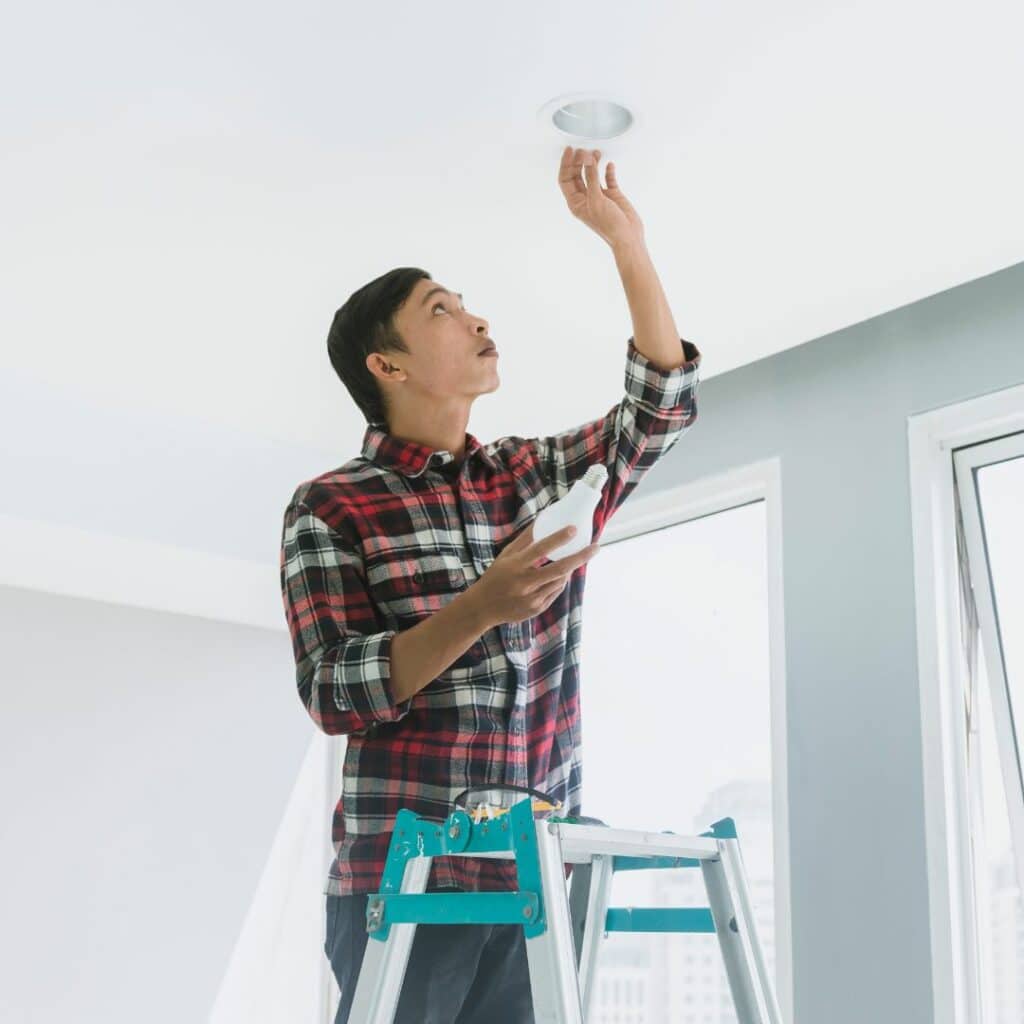 img of someone changing a lightbulb
